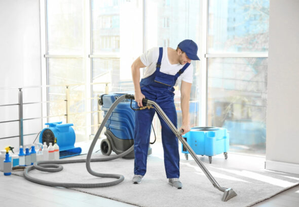 Dry Cleaner's Employee Removing Dirt From Carpet In Flat